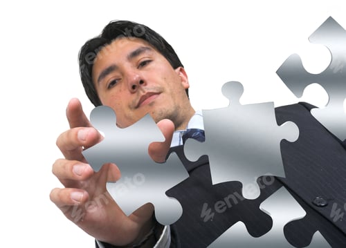 Preview: Business Man Arranging Puzzle Pieces