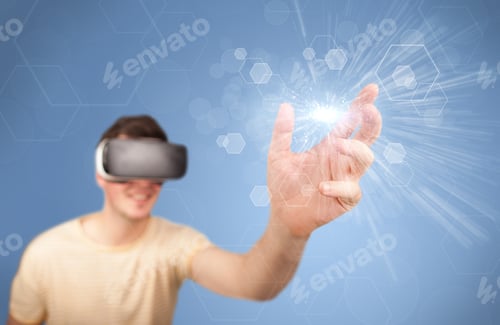 Preview: Young Impressed Man Wearing Virtual Reality Goggles With Blue Hexagons Around Him