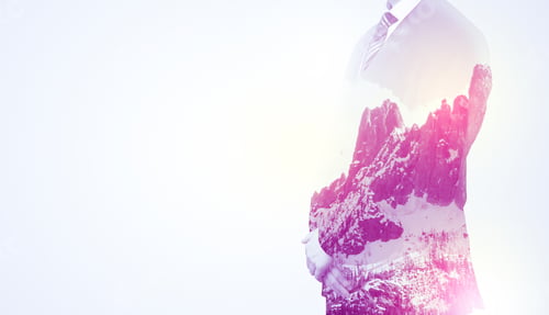Preview: Young Businessman In Suit Standing With Sunny Snowy Mountain And Trees Graphic.