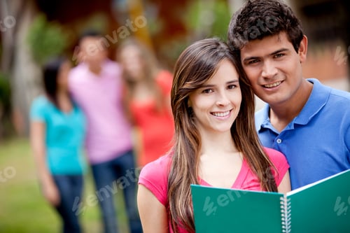 Preview: Couple Of Students With A Notebook Outdoors