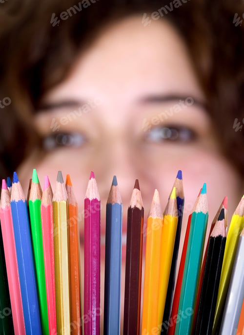 Preview: Girl With Color Pencils In Front Of Her - Focus Is On Color Pencils