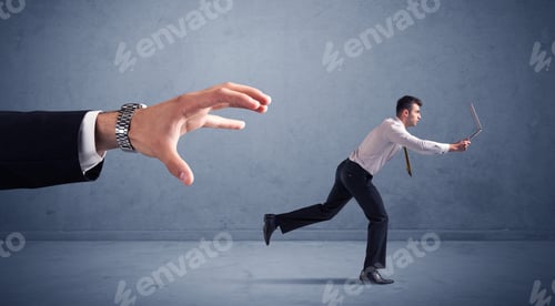 Preview: Young Miniature Businessman Running From A Big Hand With Blueish Background