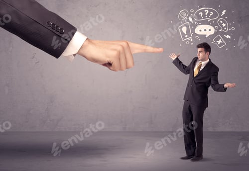 Preview: A Young Confused Businessman Being Fired By Large Boss Hand Concept With Drawn Speech Bubbles