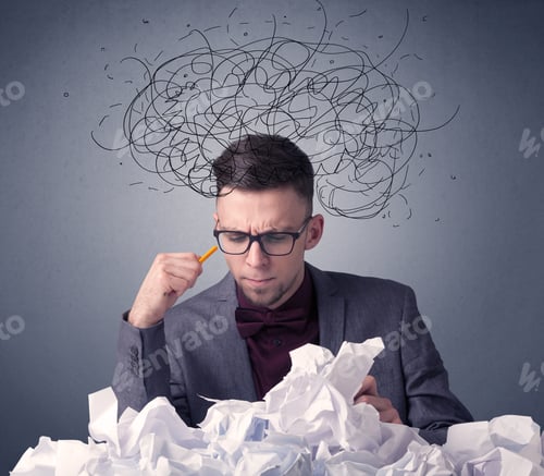 Preview: Young Businessman Sitting Behind Crumpled Paper With Scribbles Over His Head