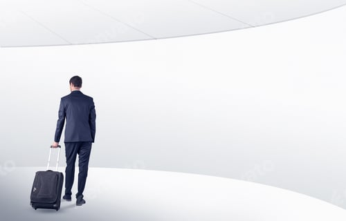 Preview: Man in Suit Pulling Suitcase in Modern Space