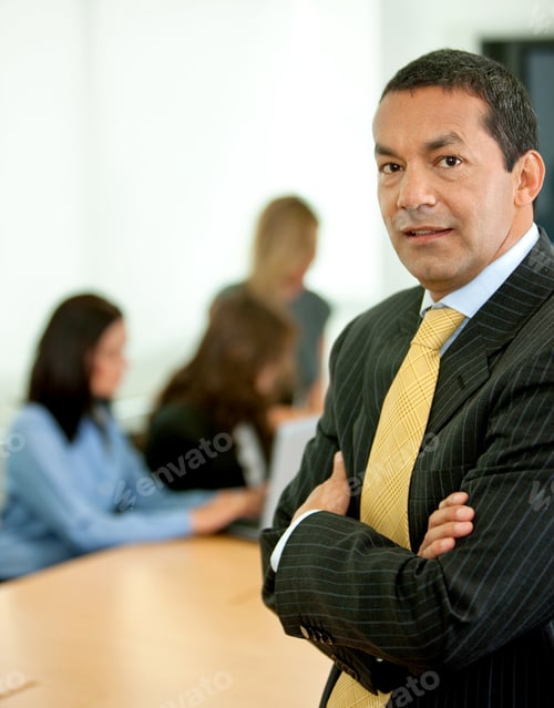Preview: Business Man Portrait In An Office With His Team Behind Him