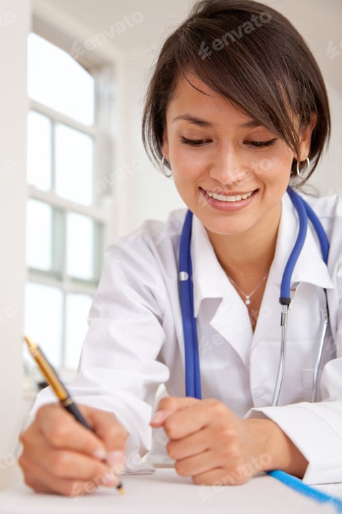 Preview: Female Doctor At The Hospital Writing A Medical History
