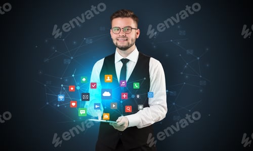 Preview: Handsome Businessman In Suit With Tablet On His Hand And Application Icons Above