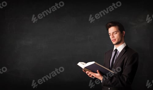 Preview: Young Adult Reading Book in Front of Blackboard