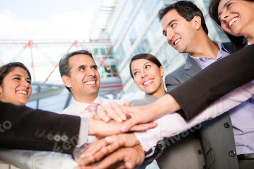 Preview: Successful Business Group With Hands Together And Smiling
