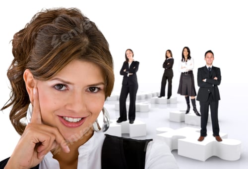 Preview: Businesswoman With Her Teamwork On Puzzle Pieces Isolated On White