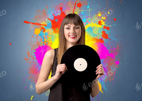 Preview: Young Lady Holding Vinyl Record On A Grey Background With Colorful Splashes Behind Her