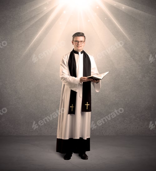 Preview: A Male Religious Young Priest In Black And White Dress Giving His Blessing, Holding The Holy Bible