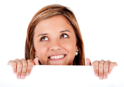Preview: Smiling Woman Looking Upward Holding a White Board
