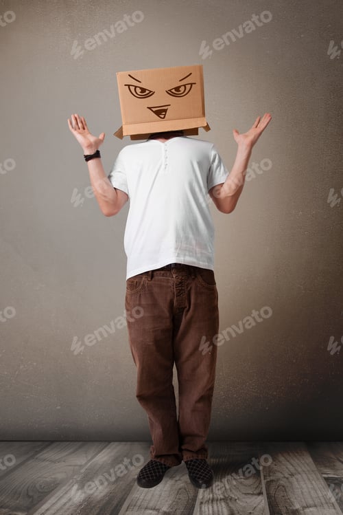 Preview: Young Man Standing And Gesturing With A Cardboard Box On His Head With Evil Face