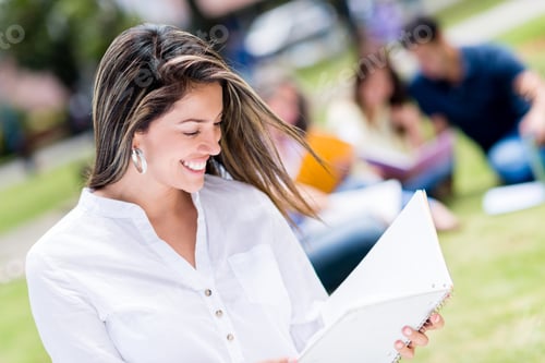 Preview: Happy Female Student Holding A Notebook Outdoors