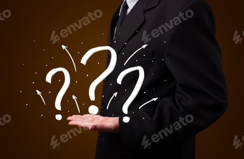 Preview: Young Business Man In Suit Presenting Hand Drawn Question Marks