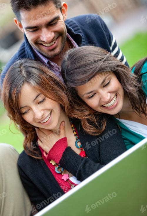 Preview: Group Of People With A Laptop Outdoors And Smiling
