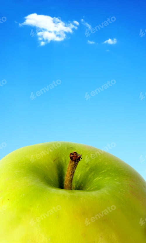 Preview: Green Apple Close Up With A Beautiful Blue Sky In The Background