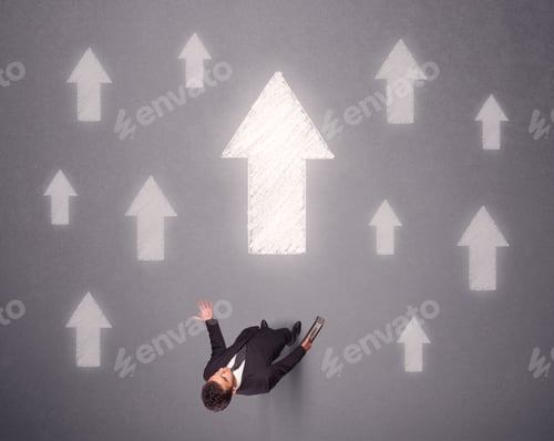 Preview: Young Contemplating Businessman Stands In Front Of White Arrows