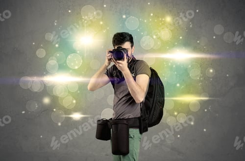 Preview: A Young Amateur Photographer With Professional Camera Equipment Taking Picture In Front Of Grey