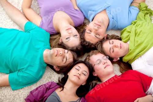Preview: Group Of Friends Together Lying On The Floor With Eyes Closed