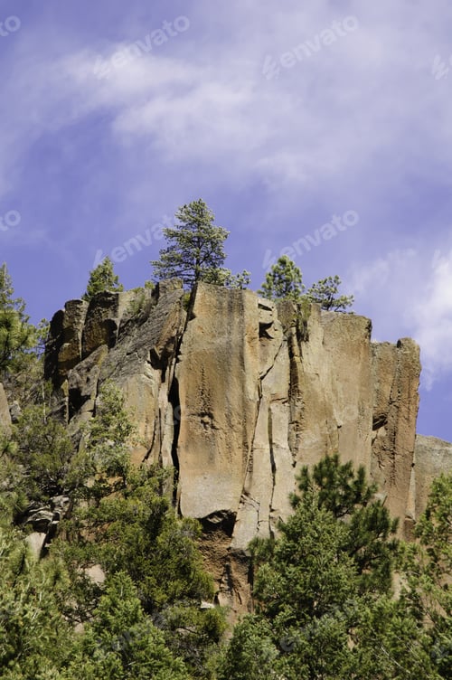 Preview: Cliff With Pines Under Partly Cloudy Sky High In Jemez Mountains In Northern New Mexico