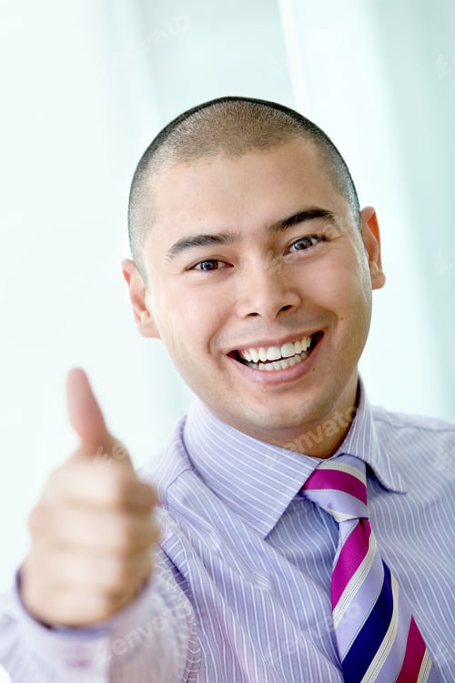 Preview: Business Man Smiling With Thumb Up At The Office