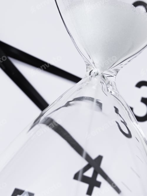 Preview: Time Running Out: White Sand Falling Inside Hourglass, With Analog Clock In Background (Focus On