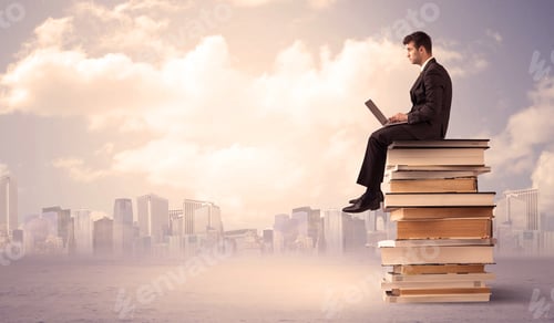Preview: A Serious Student With Laptop Tablet In Elegant Suit Sitting On A Stack Of Books In Front Of