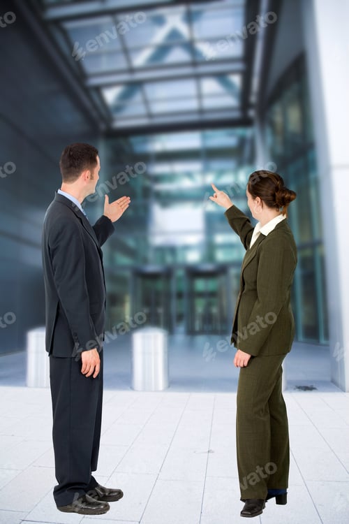 Preview: Business Couple Pointing At A Modern Building