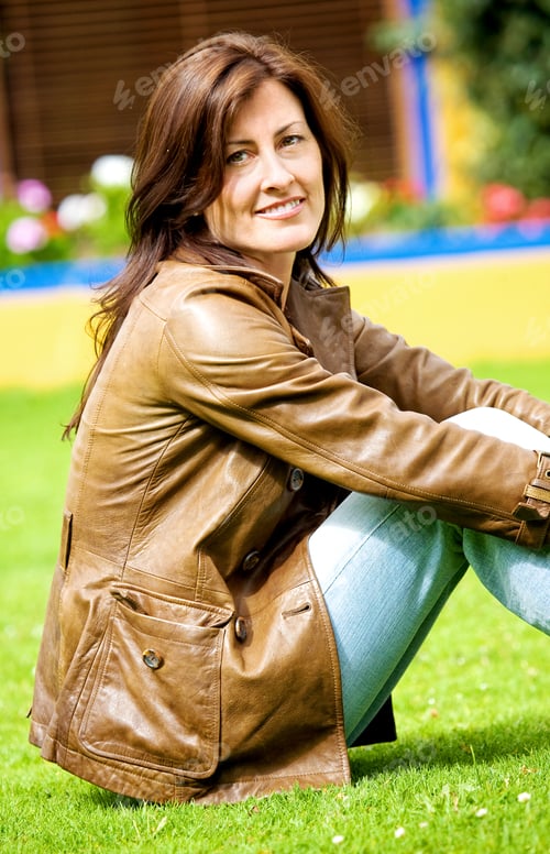 Preview: Beautiful Woman Portrait Smiling Outside Her Home Sitting On The Grass