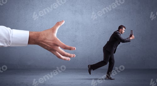 Preview: Young Miniature Businessman Running From A Big Hand With Blueish Grey Background