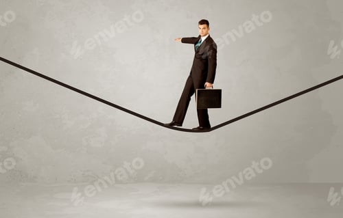 Preview: An Elegan Businessman In Suit Balancing On A Tight Rope With A Briefcase In Front Of Grey Urban