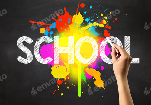 Preview: Female Hand Holding White Chalk In Front Of A Blackboard With School Written On It And A Colorful