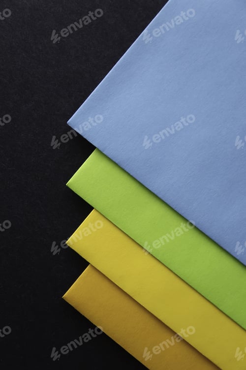 Preview: Four Colored Envelopes On Black Cardboard