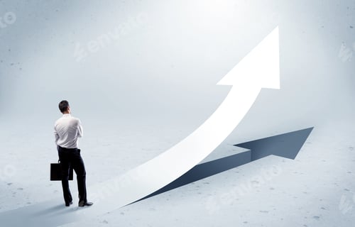 Preview: A Young Adult Salesman Standing In Front Of A Big Arrow Pointing Up With A Shadow In Grey Empty