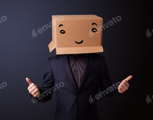 Preview: Young Man Standing And Gesturing With A Cardboard Box On His Head With Smiley Face