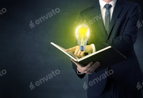Preview: Businessman Holding Book With Bulb.