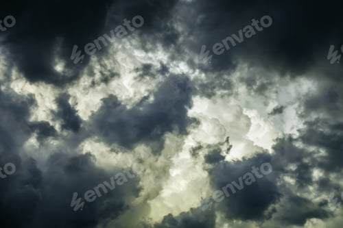 Preview: Storm Clouds In Summer: Ragged Wind-Driven Dark Clouds Move In Quickly To Obscure Large White