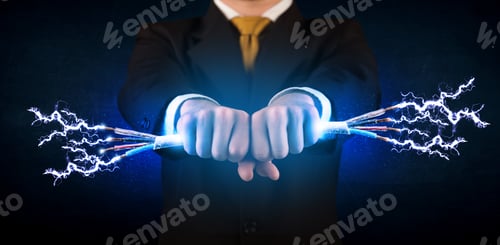 Preview: Business Person Holding Electrical Powered Wires Concept On Background