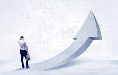Preview: Young Sales Business Person In Elegant Suit Standing With His Back In Front Of A Big Arrow Pointing