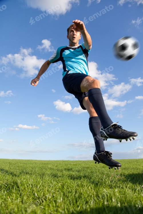 Preview: Handsome Male Football Player Kicking The Ball