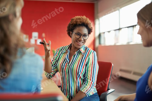Preview: Unposed Group Of Creative Business People In An Open Concept Office Brainstorming Their Next