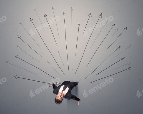 Preview: Young Contemplating Businessman Stands In Front Of Grey Arrows