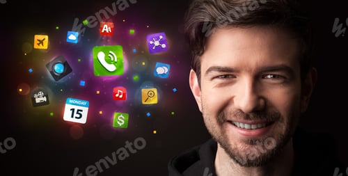 Preview: Portrait Of A Young Businessman With Colorful Applications Next To Him On A Dark Background