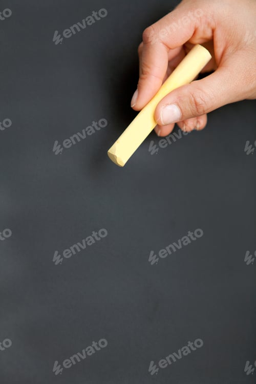 Preview: Blackboard With A Hand Holding A Yellow Chalk