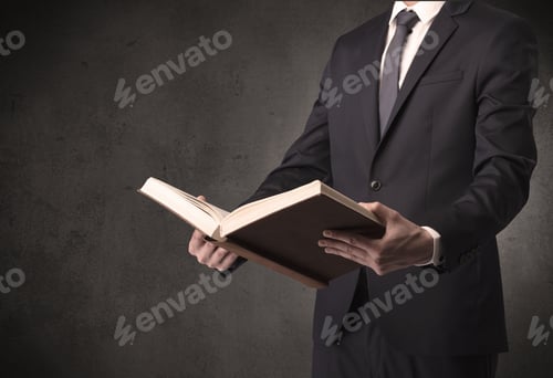 Preview: Businessman Holding A Book In His Hand.
