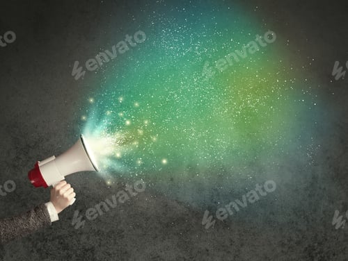 Preview: Caucasian Business Hand Holding Megaphone With White Sparkles On A Grunge Background