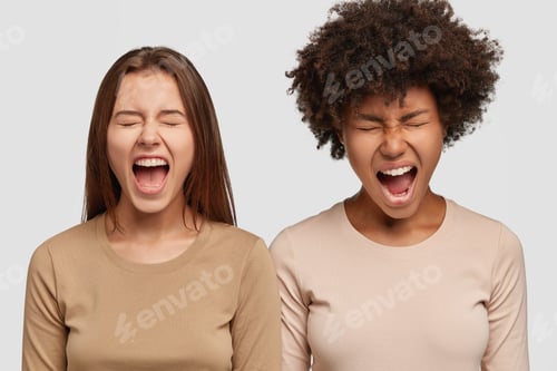 Preview: Image Of Stressful Two Women Scream Loudly, Keeps Mouthes Widely Opened, Have Quarrel With